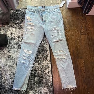 Light Blue Jeans, fitted, skinny, rips made into the legs.